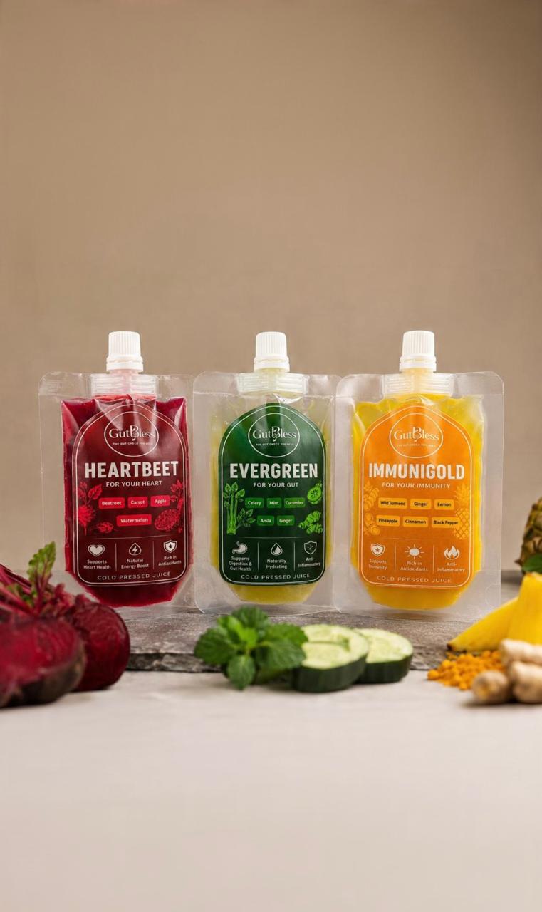Studio shot of the three GutBless juice pouches with fresh ingredients